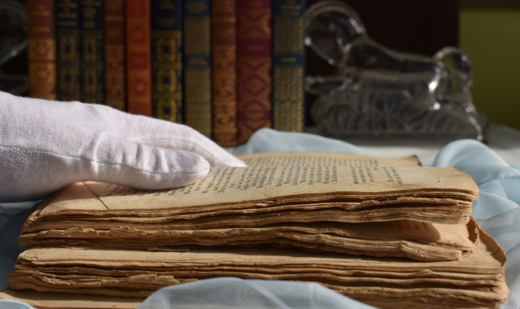 historical book in need of digital preservation receiving white glove handling