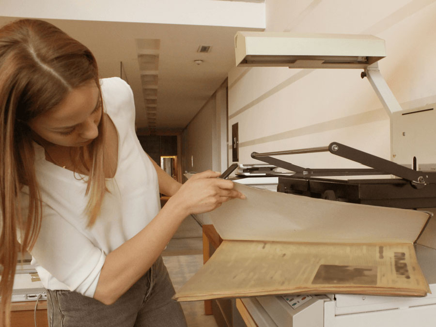 Woman scanning newspaper