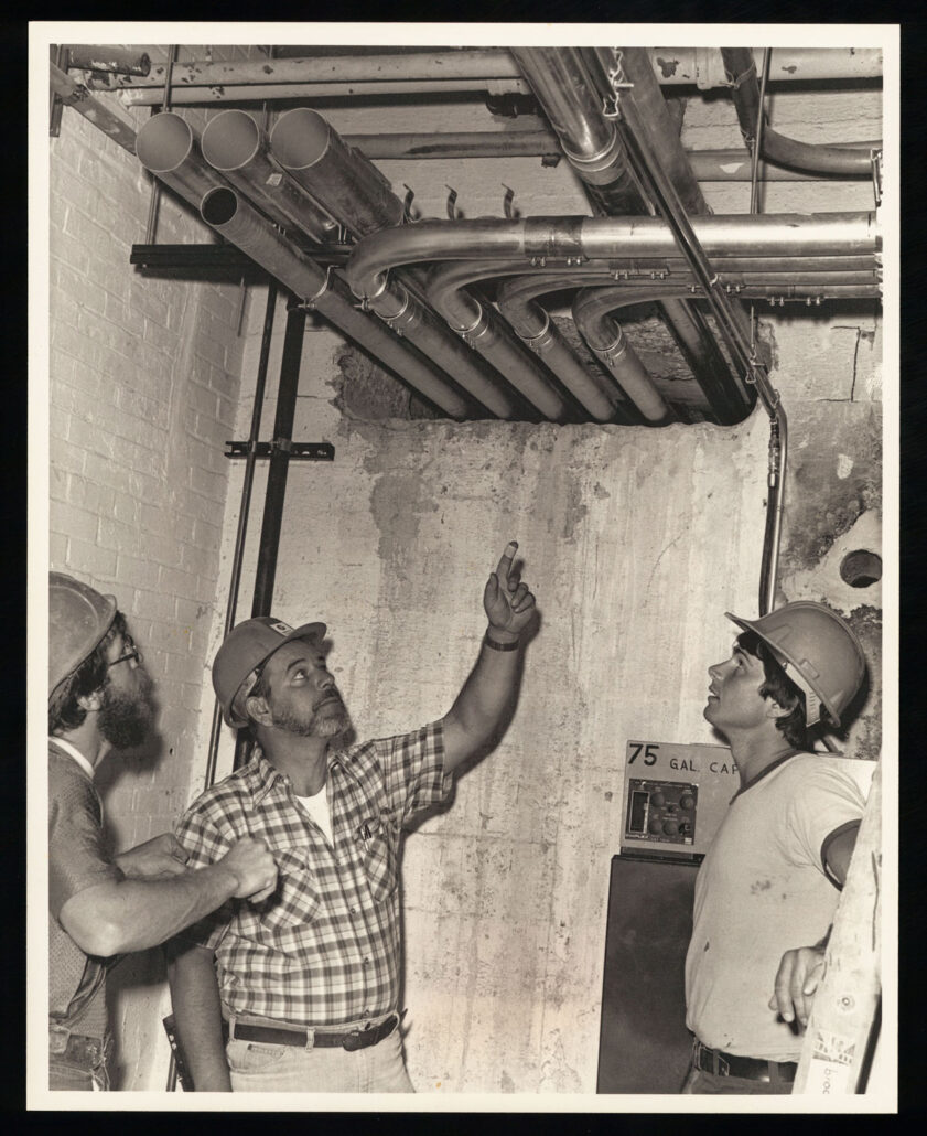workers analyzing pipe