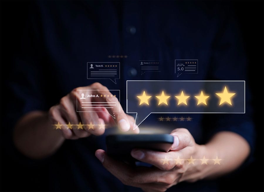 Hands tapping on phone screen with five star rating hovering above
