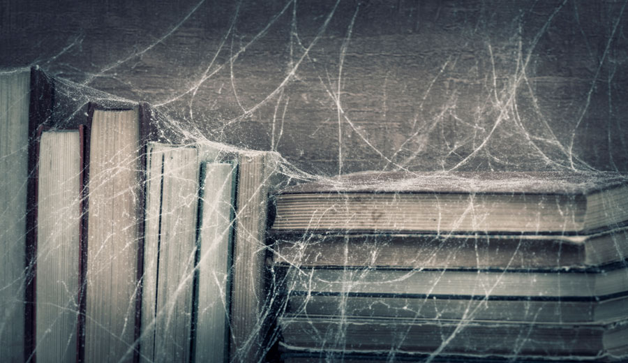books covered in cobwebs