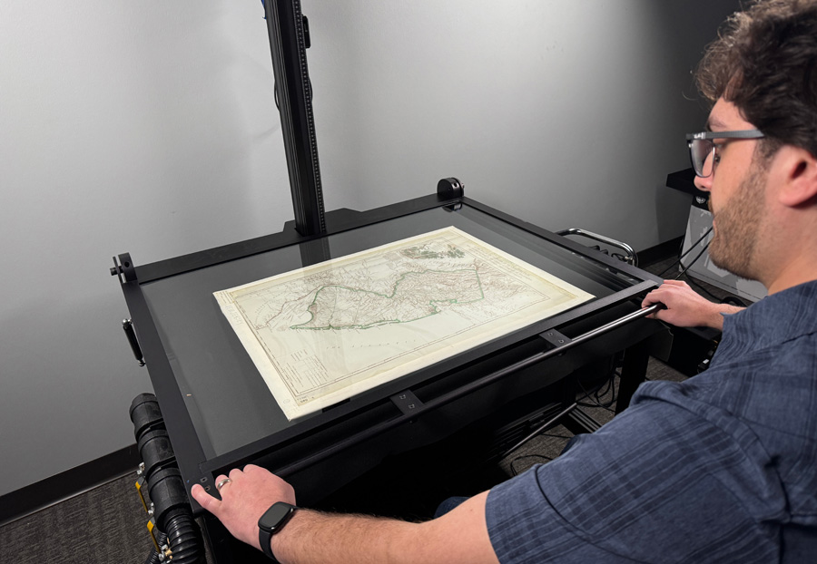 Digitization technician scanning a map