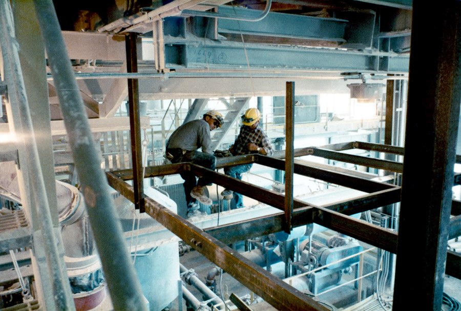 Workers sitting on a beam