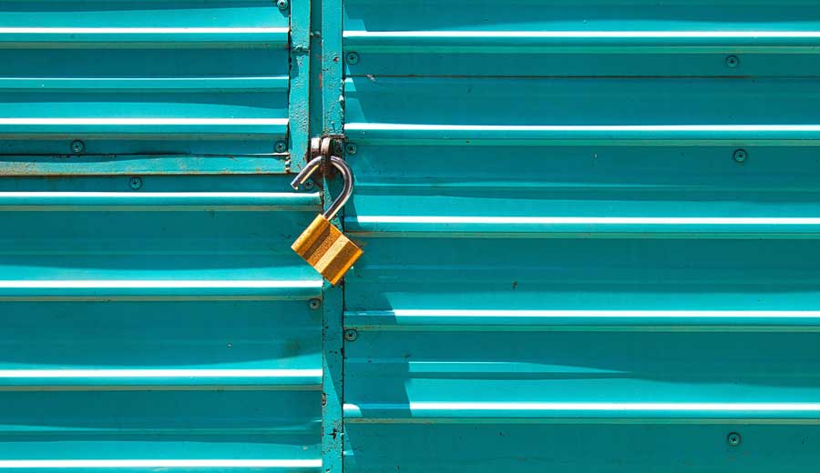 An unlocked padlock against a teal background